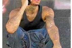 One Arrested, Another Sought in Shooting Death