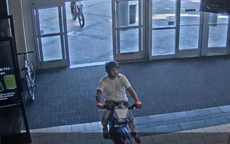 Pair ride through mall on dirt bikes
