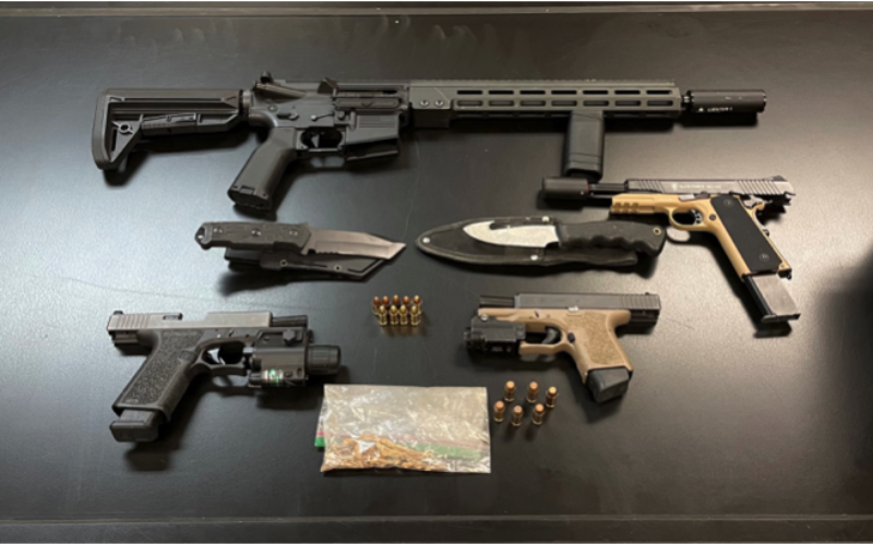 Two Arrested After Probation Compliance Check Reportedly Leads to Discovery of Guns, Illegal Quantity of Cannabis